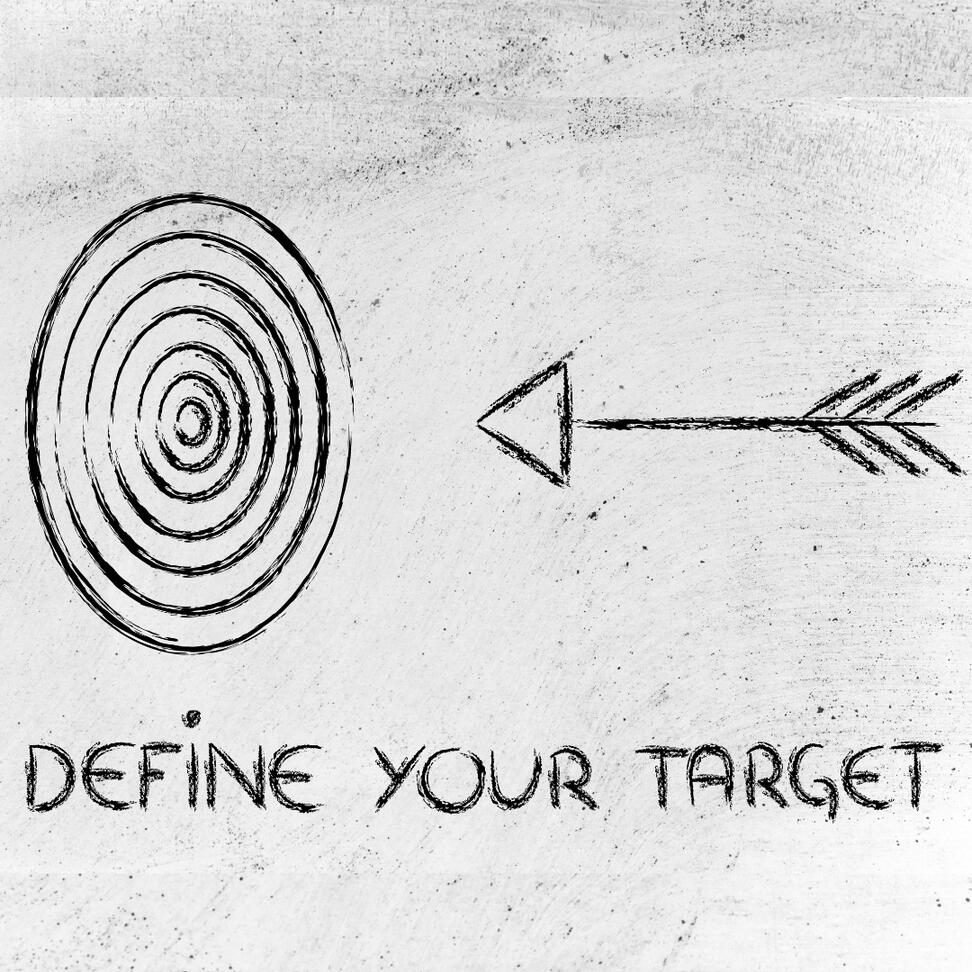 drawn arrow on a chalkboard targeting an aim, illustrating the idea of defining and targeting audience